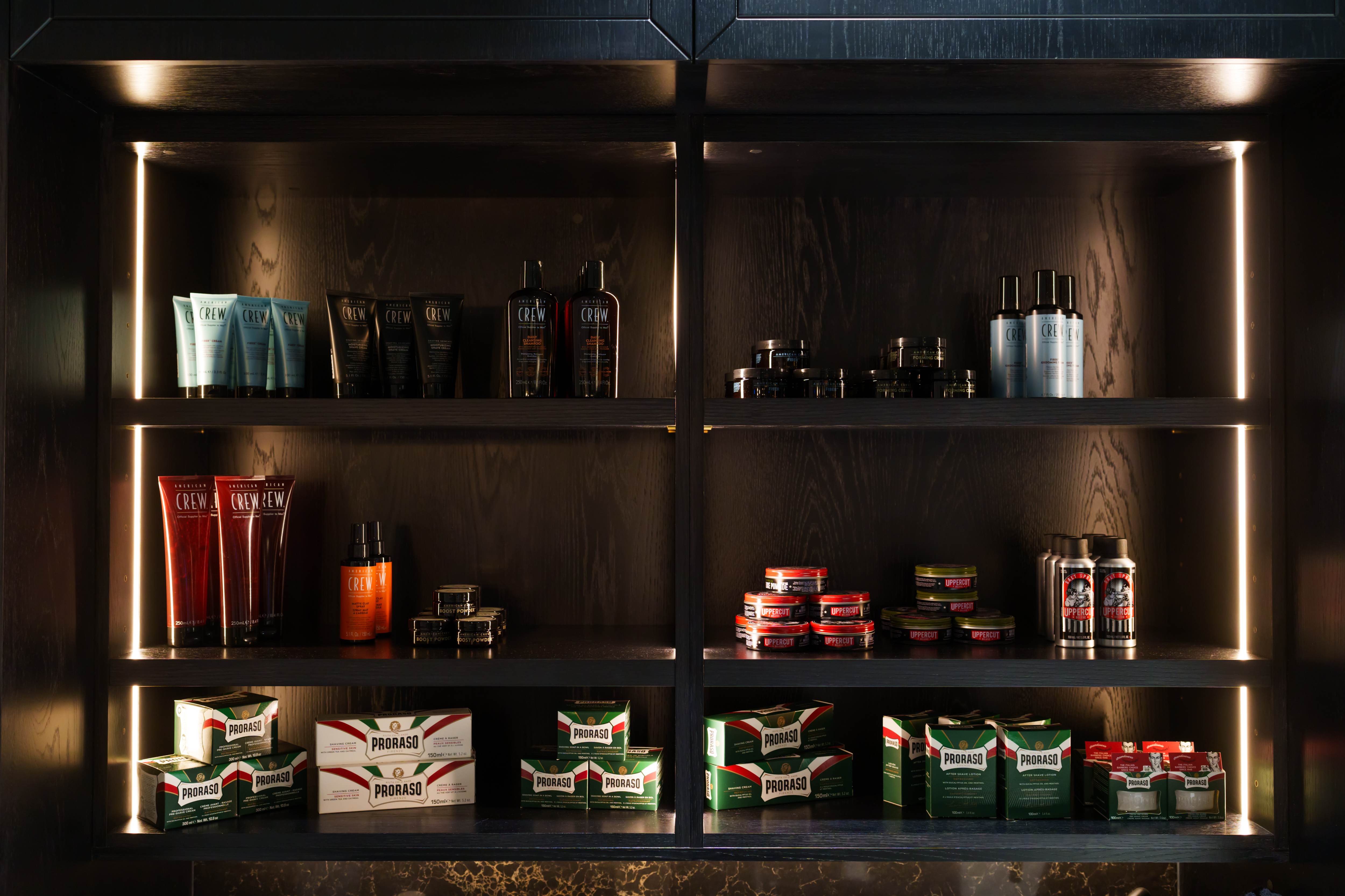 Premium barbering products on illuminated shelves