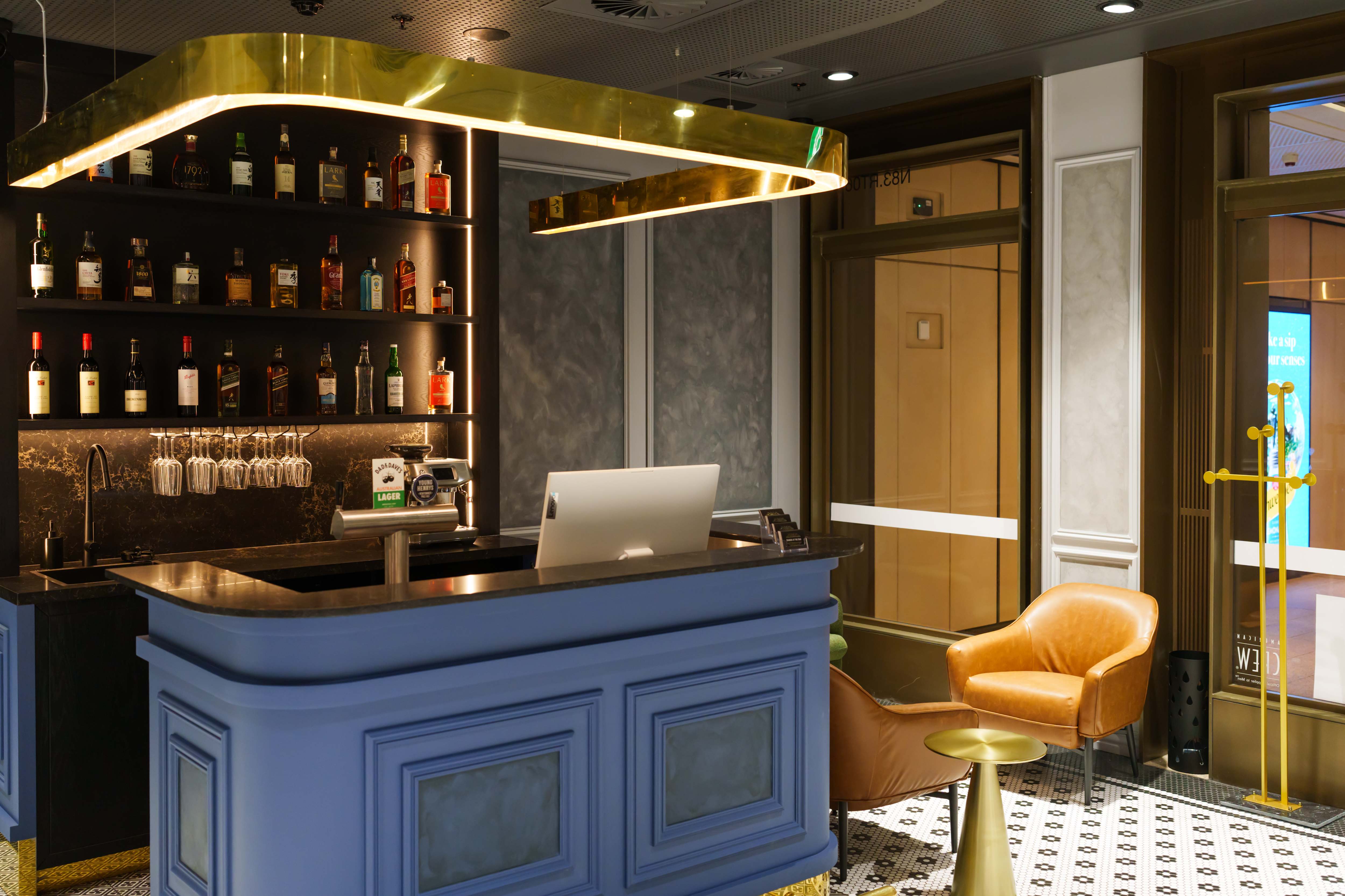 Blue bar counter with backlit bottle display