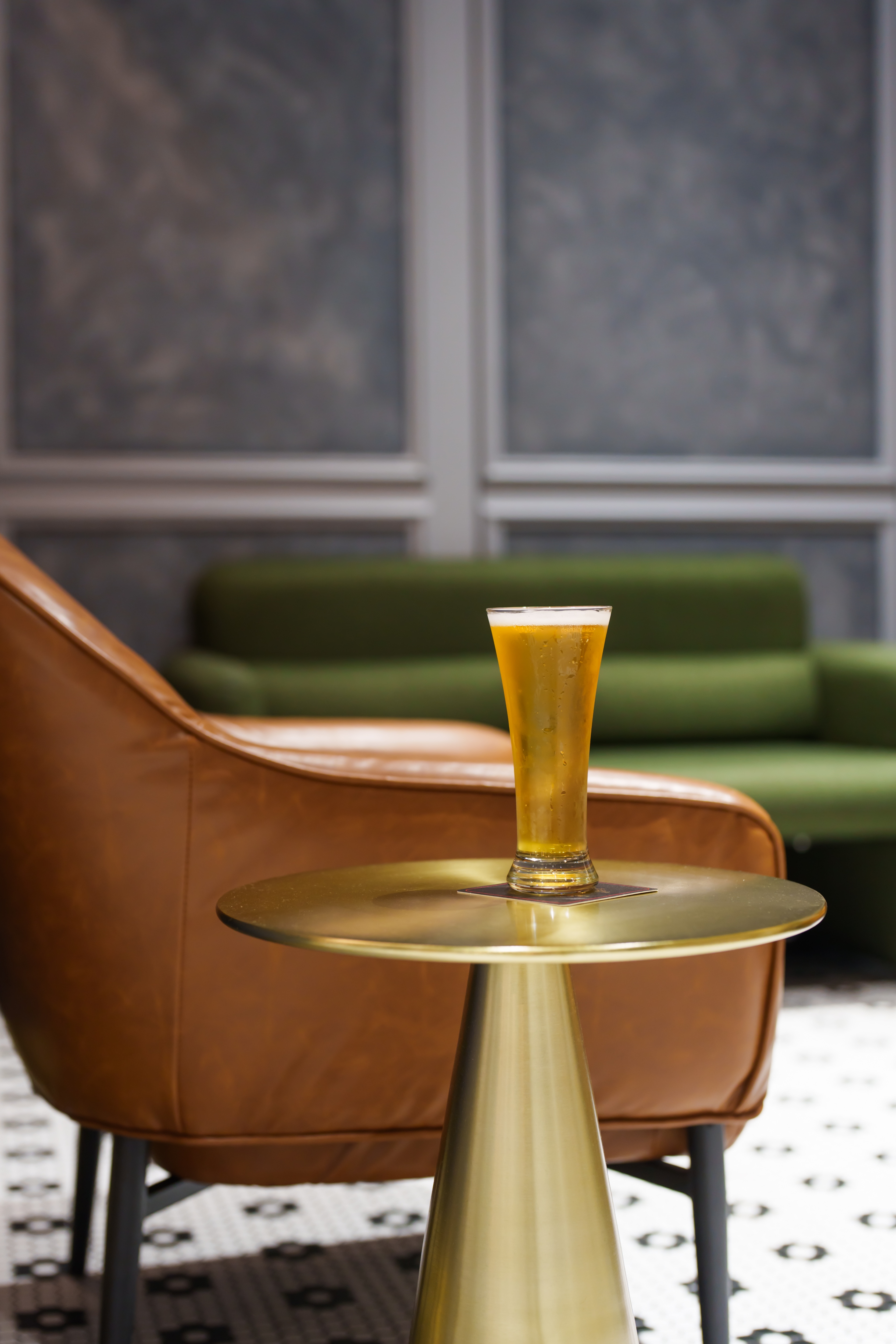 Cold beer on brass table with lounge seating